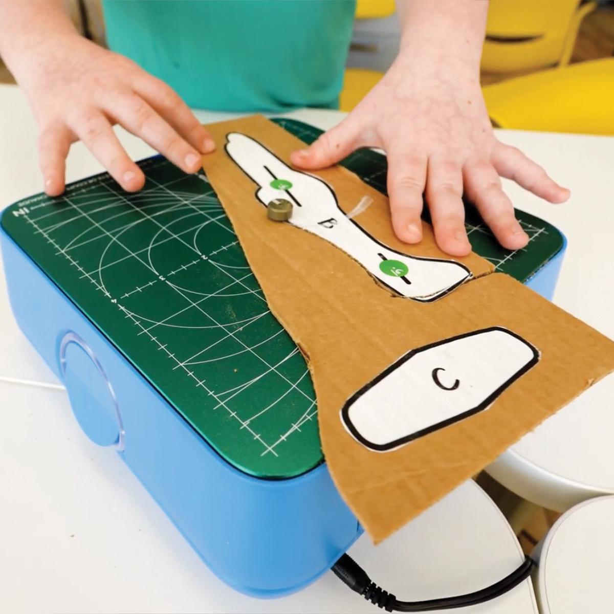 Image depicting cutting cardboard with the ChompSaw