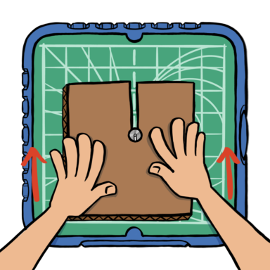 Hands pushing cardboard into ChompSaw